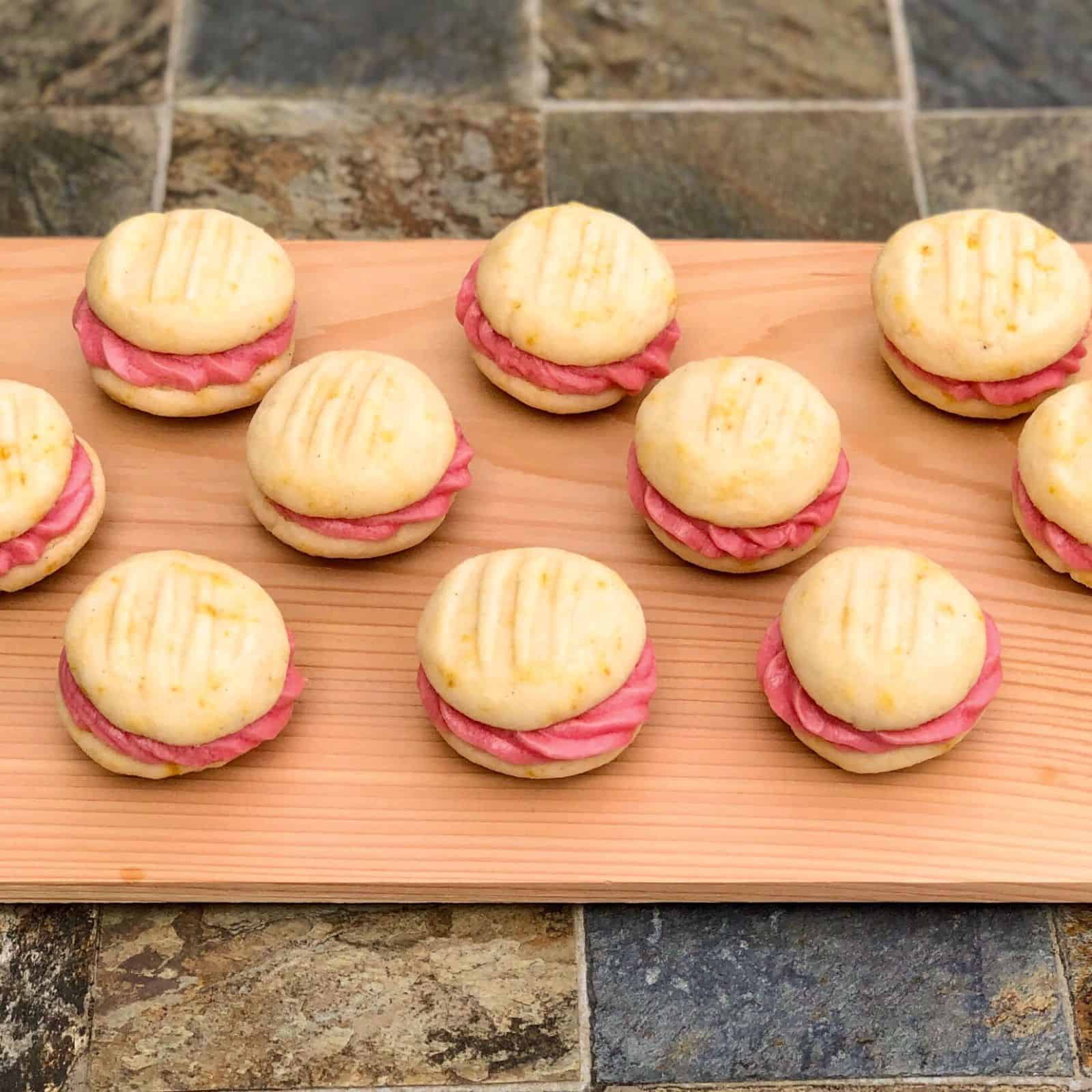 several Blood Orange Melting Moments on a wooden board.
