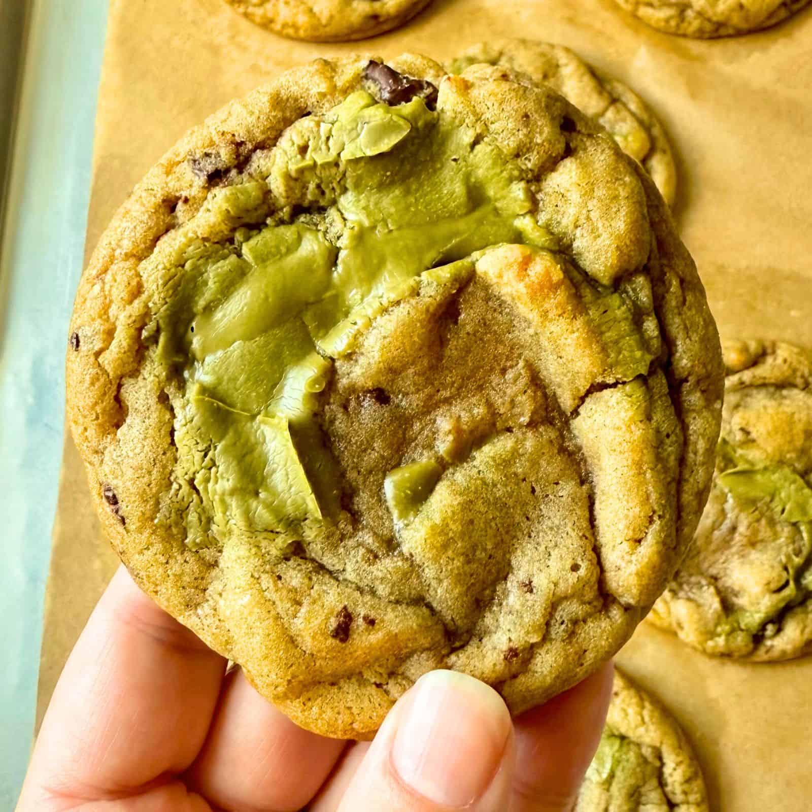 a hand holding a Dubai Chocolate Chip Cookie