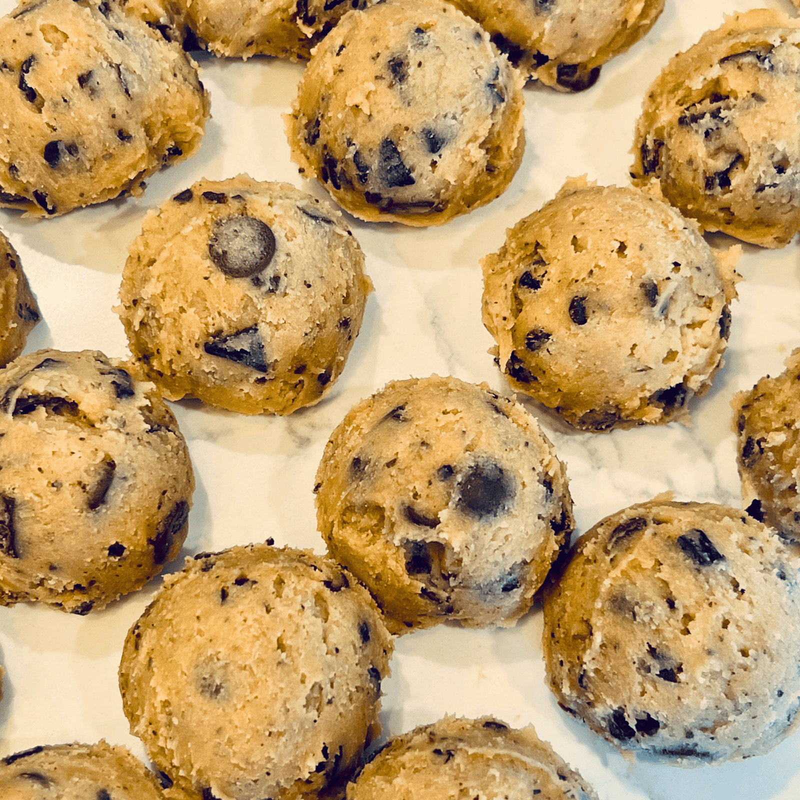 lined-up cookie dough waiting to be baked.